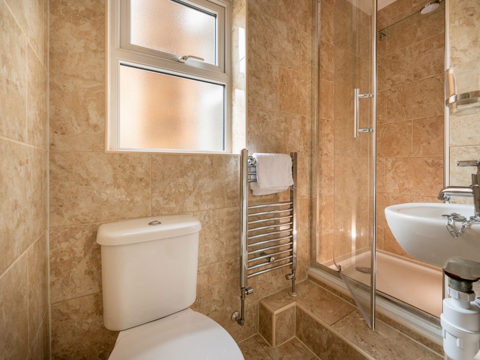 A bathroom with a toilet, shower, and sink at The Ravines in Scarborough