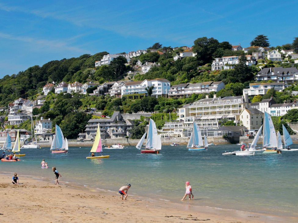 A beach with sailboats and people at Primrose Cottage in Salcombe