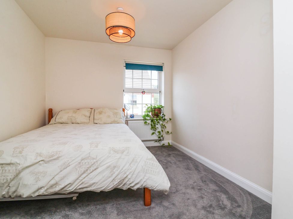 A bedroom with a bed and a window at Manning's View Barnstaple