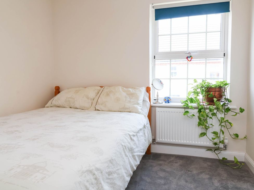 A bedroom with a bed and window at Manning's View in Barnstaple
