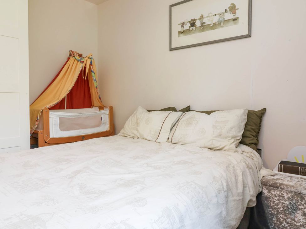 A bedroom with a bed and a crib at Manning's View in Barnstaple
