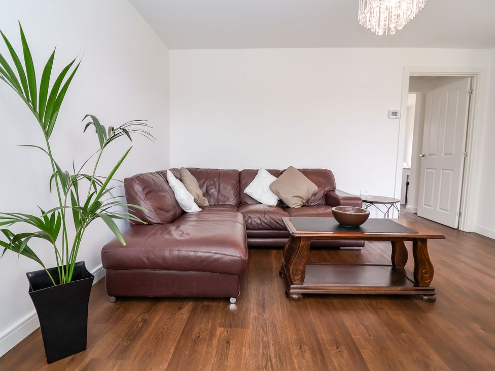 A living room with a couch and coffee table at 12 Corbetts Close in Crewe