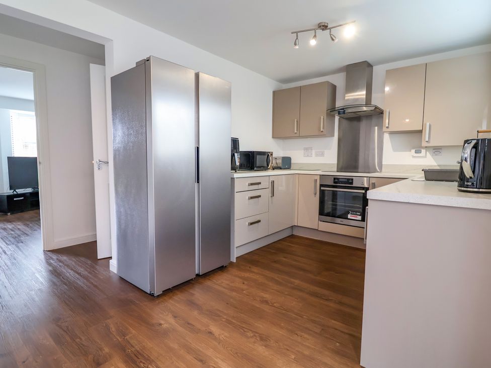 A kitchen with appliances and cabinetry at 12 Corbetts Close in Crewe