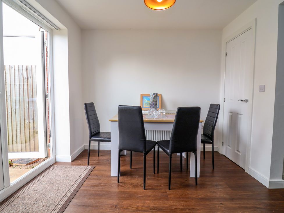 A dining room with a table and chairs at 12 Corbetts Close in Crewe