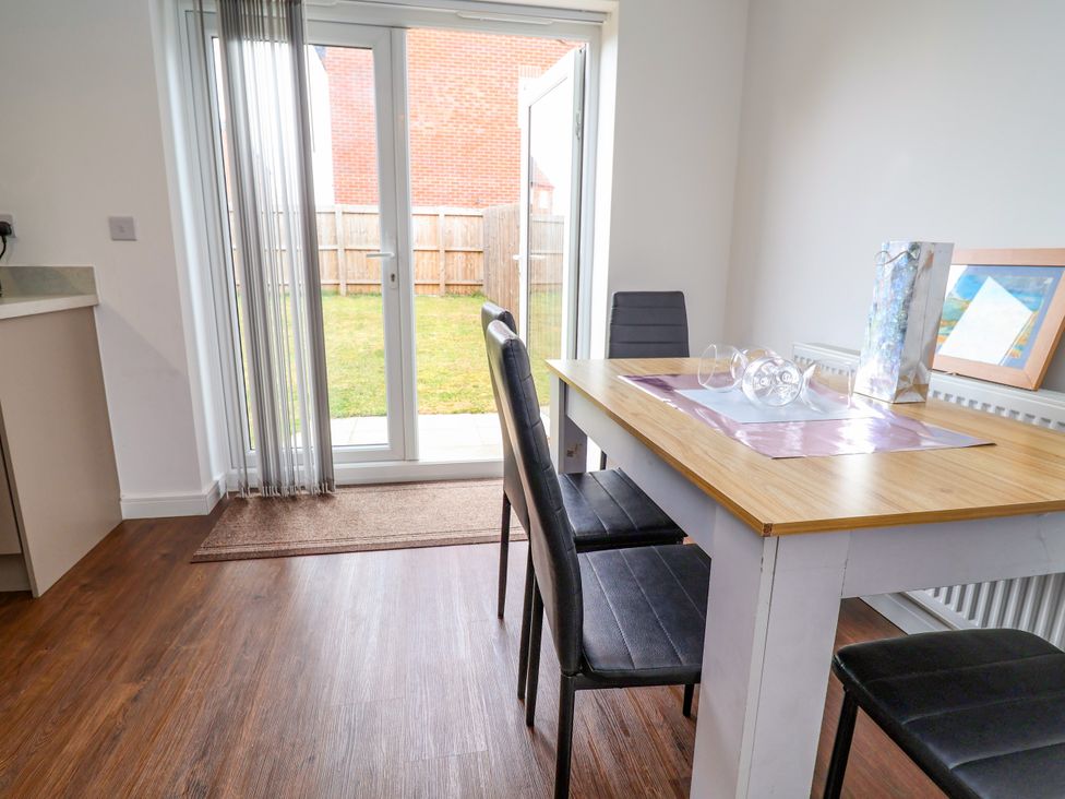 A dining room with a table and chairs at 12 Corbetts Close in Crewe