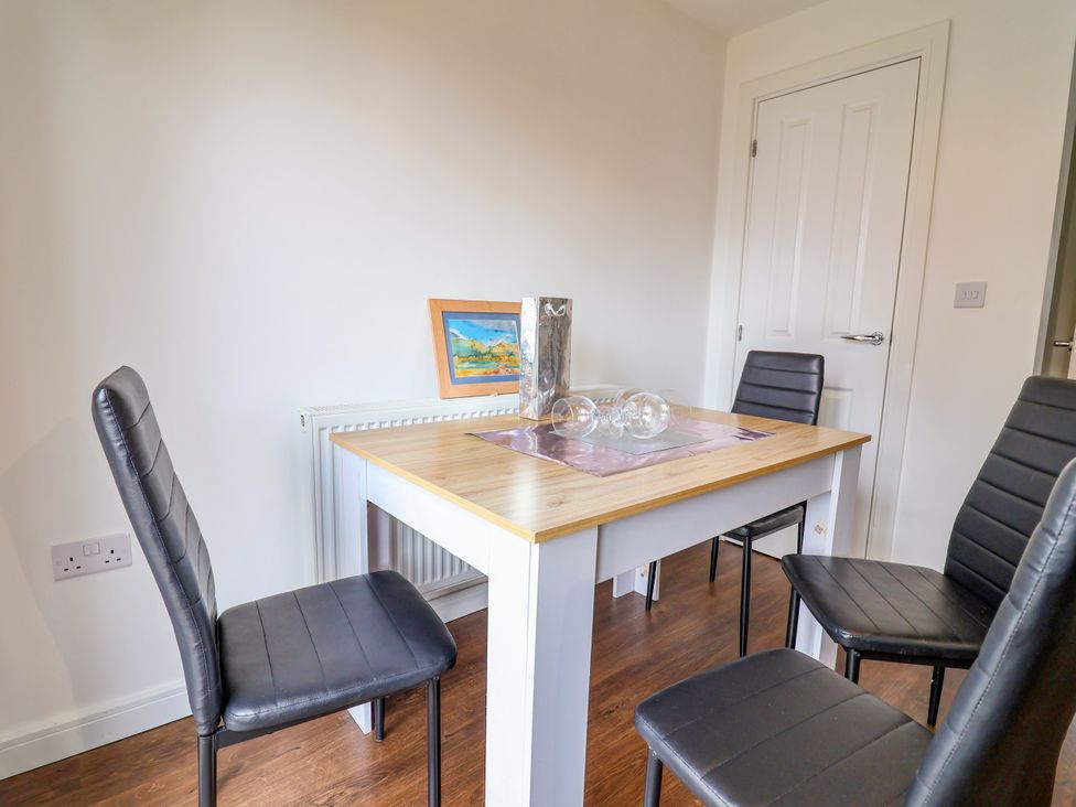 A dining room with a table and chairs at 12 Corbetts Close Crewe