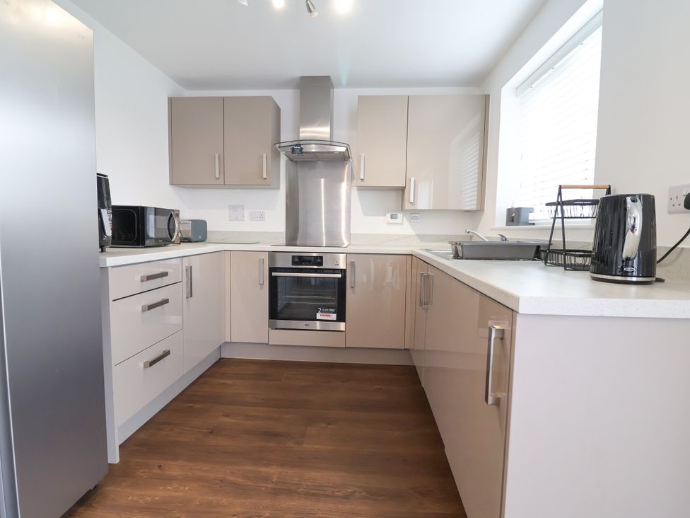 A kitchen with appliances and cabinets at 12 Corbetts Close Crewe