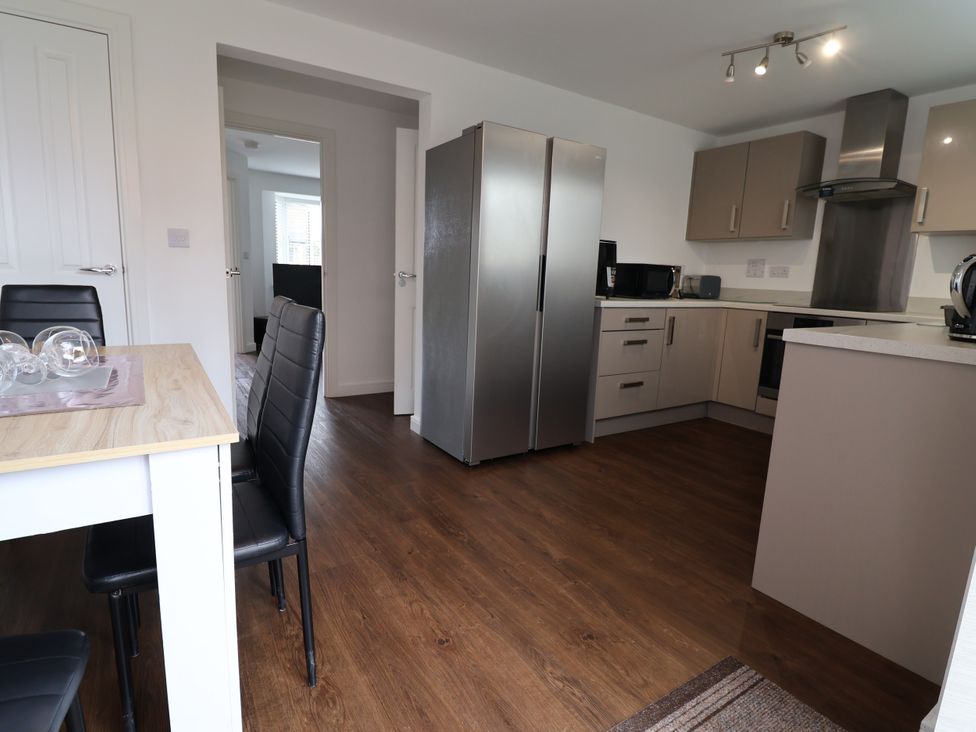 A kitchen with table and chairs at 12 Corbetts Close Crewe