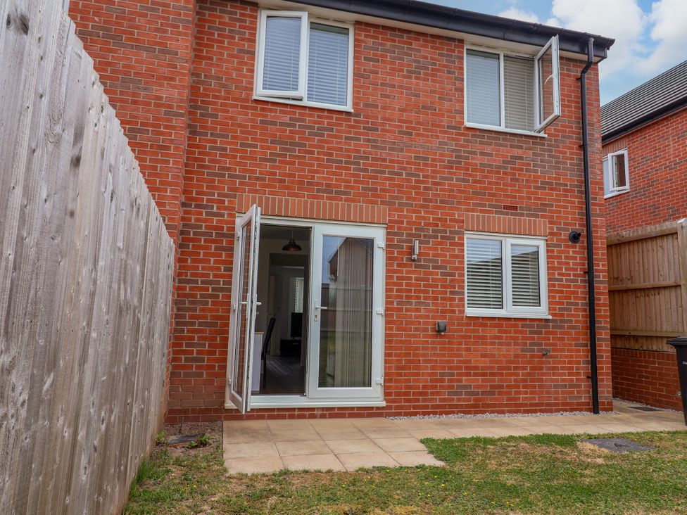 A patio area with a door and windows at 12 Corbetts Close in Crewe