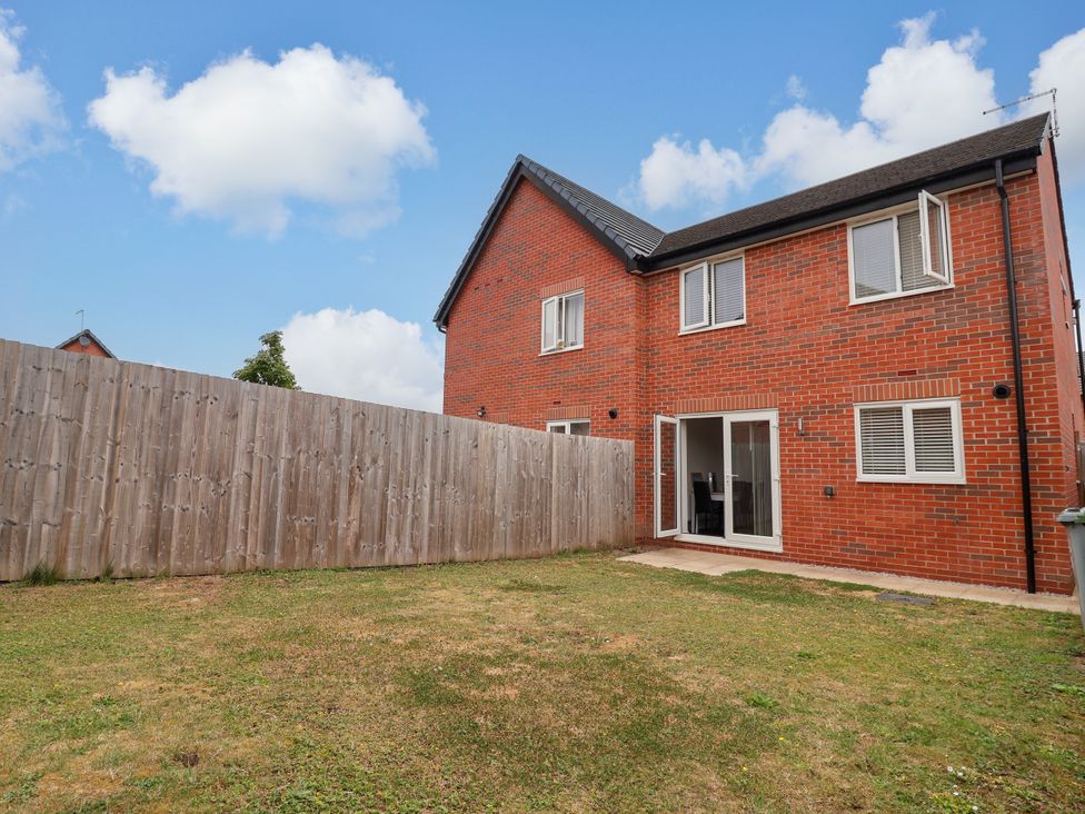 A house with a backyard and wooden fence at 12 Corbetts Close Crewe