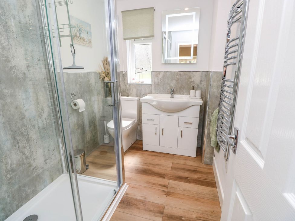 A bathroom with a shower, toilet and sink at The Old Post Office St. Lawrence near Ventnor