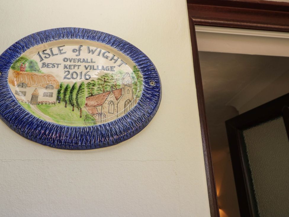 A plaque recognizing the village as the best kept village 2016 at The Old Post Office St. Lawrence near Ventnor