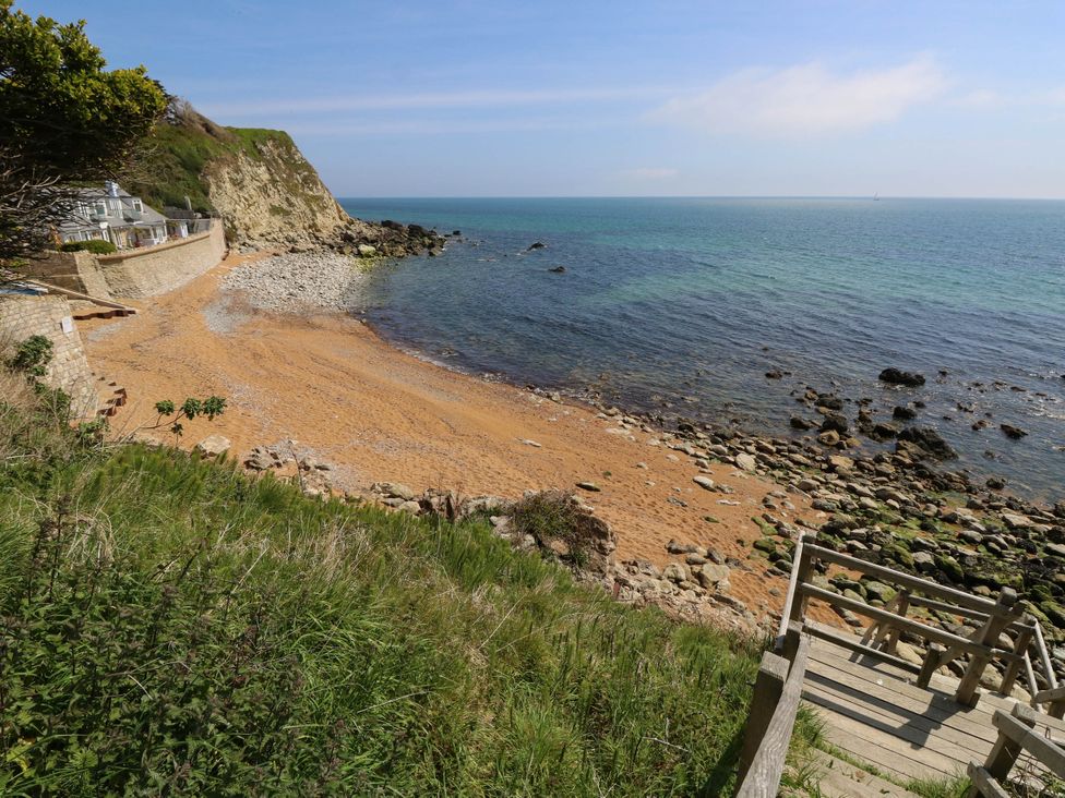 A beach with sand and water at The Old Post Office in St. Lawrence near Ventnor
