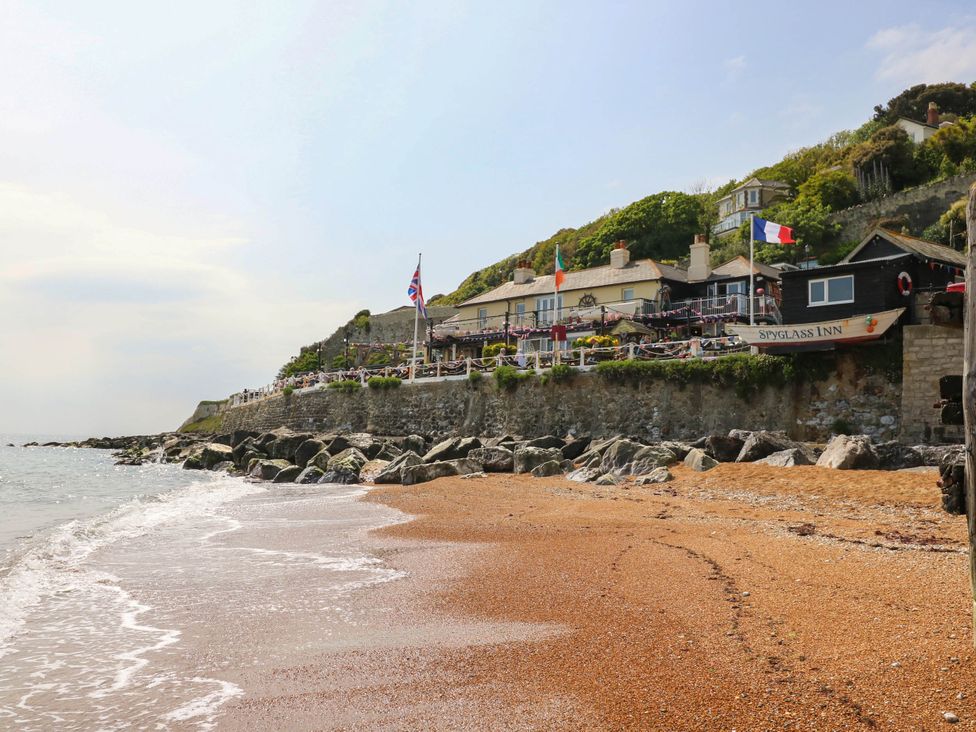 A beach with rocks and an inn at The Old Post Office in St. Lawrence near Ventnor