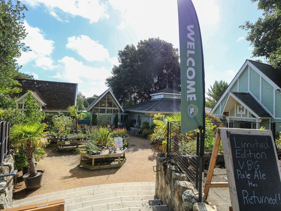 An outdoor area with plants and buildings at The Old Post Office in St. Lawrence near Ventnor