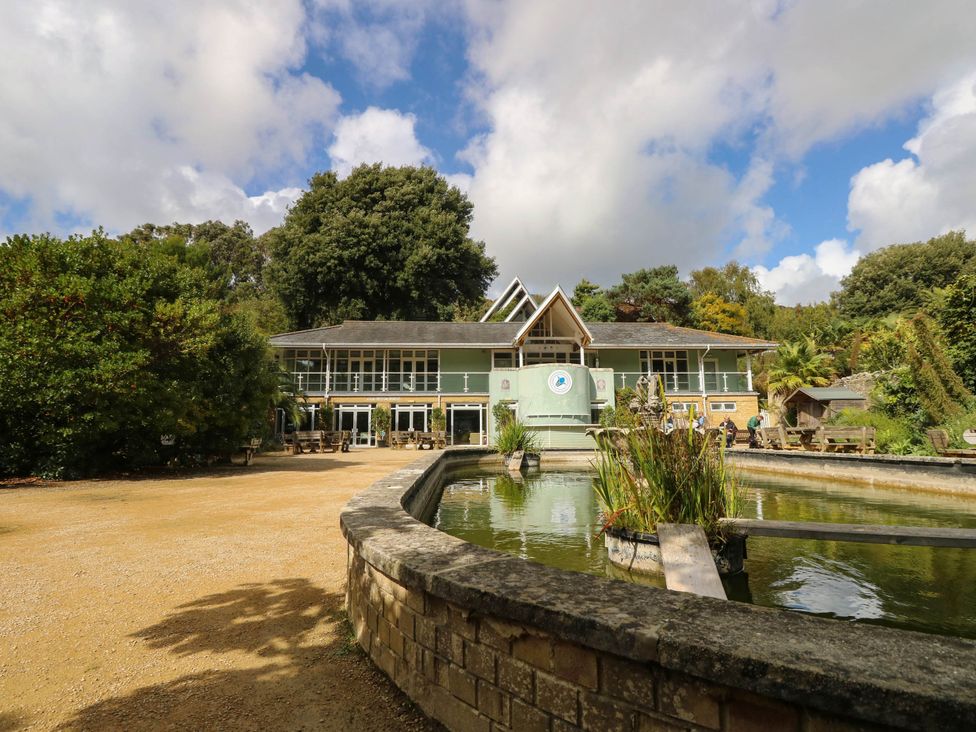 An outdoor area with a building and pond at The Old Post Office St. Lawrence near Ventnor