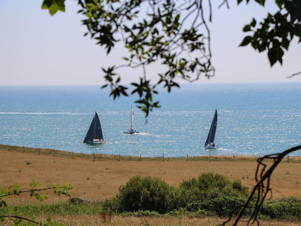 Sailing boats on the ocean near grassland at The Old Post Office St. Lawrence near Ventnor
