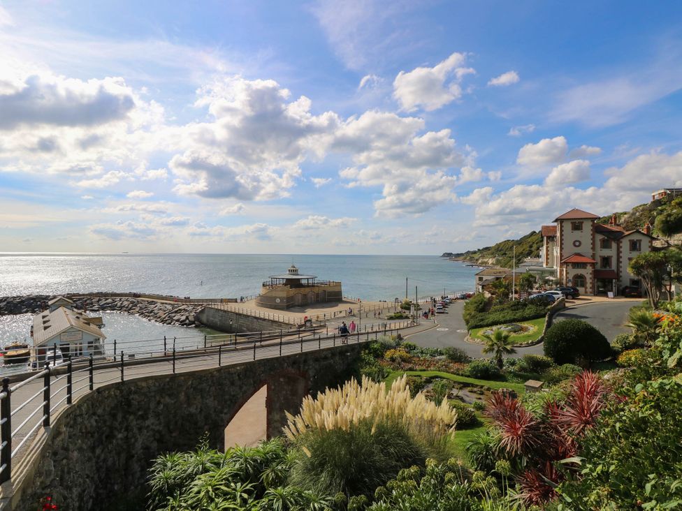 A view of the sea and pier near buildings at The Old Post Office in St. Lawrence near Ventnor