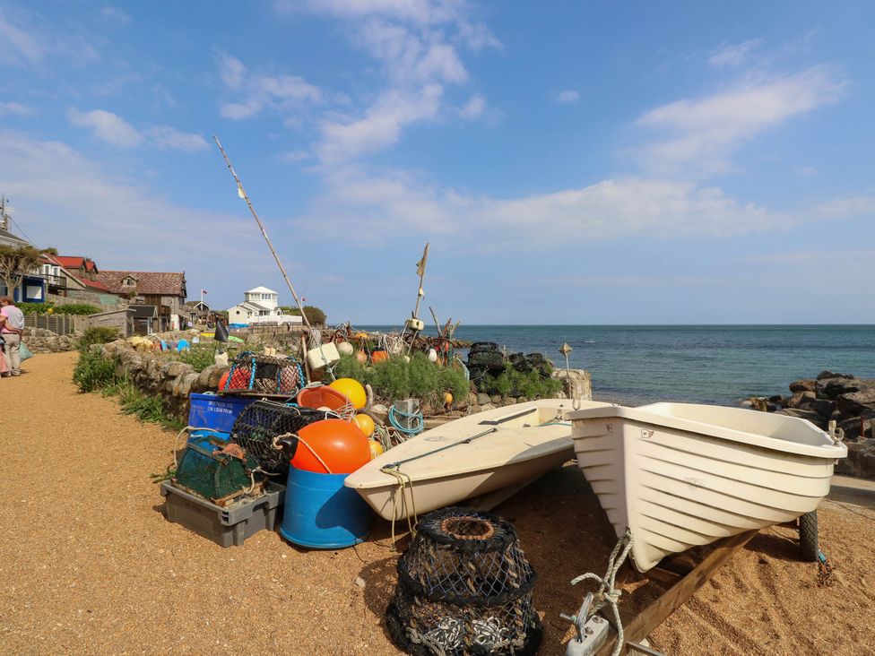 A beach with boats and fishing equipment at The Old Post Office St. Lawrence near Ventnor