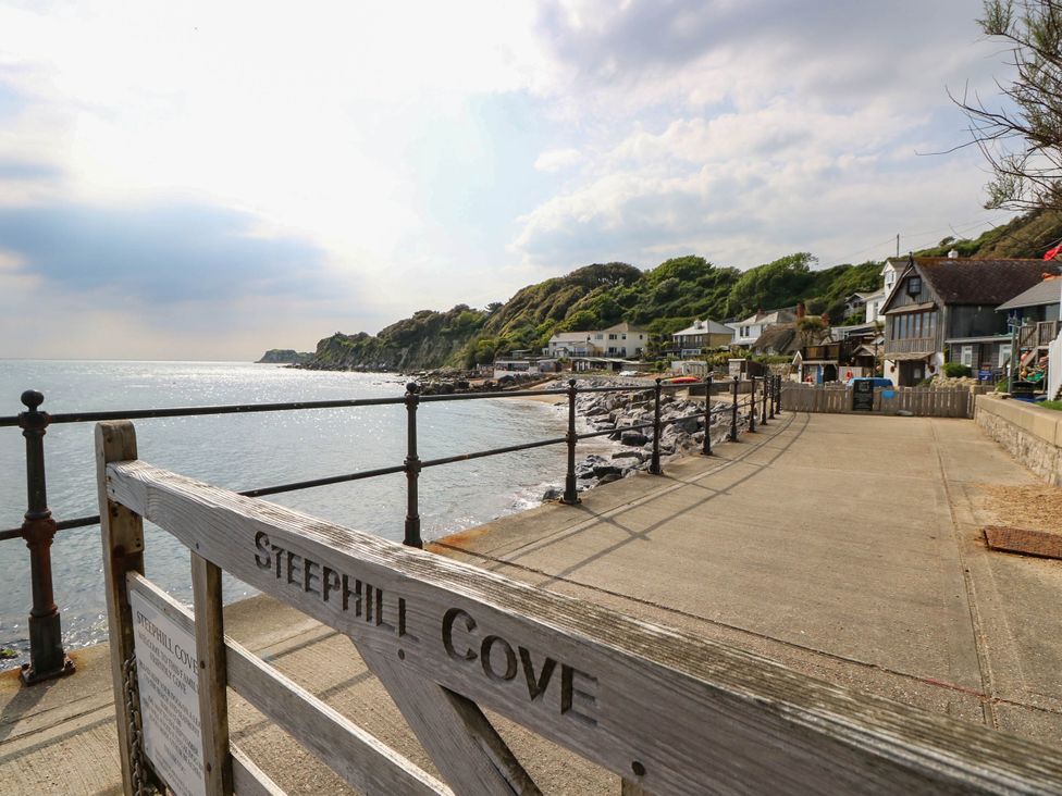A coastal view with houses and a pathway at Steephill Cove near Ventnor