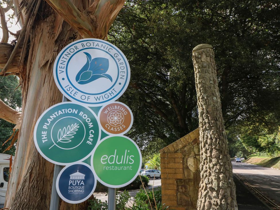 A sign for Ventnor Botanic Garden and nearby establishments at The Old Post Office St. Lawrence near Ventnor