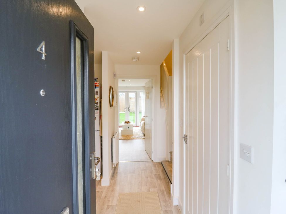 An entryway featuring a front door and hallway at Serenity House