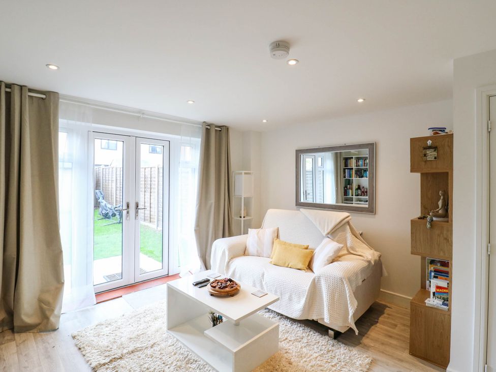 A living room with a sofa and coffee table at Serenity House 
