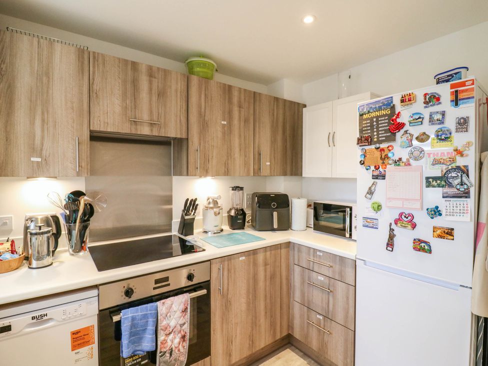 A kitchen with cabinets, refrigerator, and microwave at Serenity House