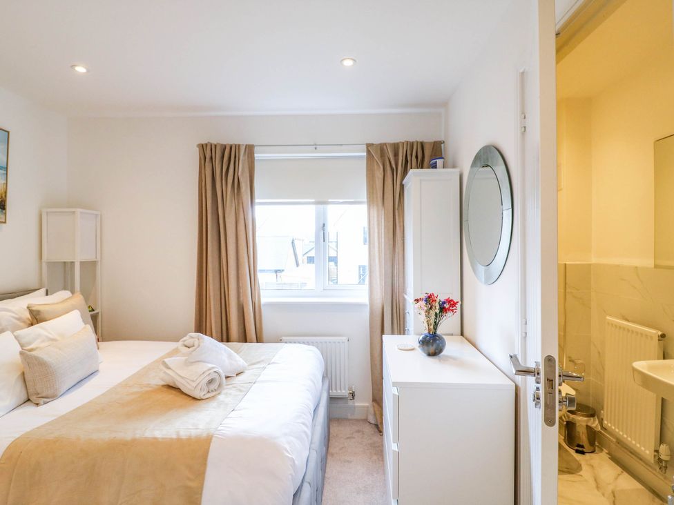 A bedroom with a bed and a mirror at Serenity House