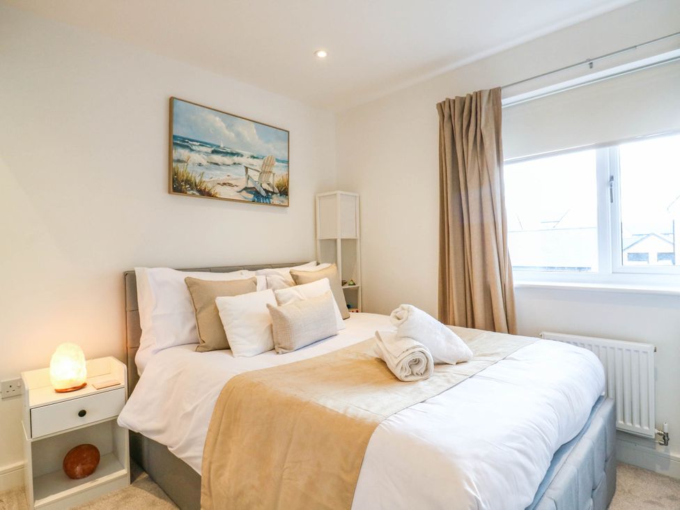 A bedroom with a bed and a painting at Serenity House