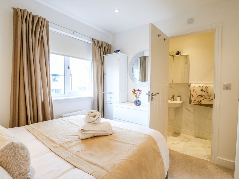 A bedroom with a bed and attached bathroom at Serenity House