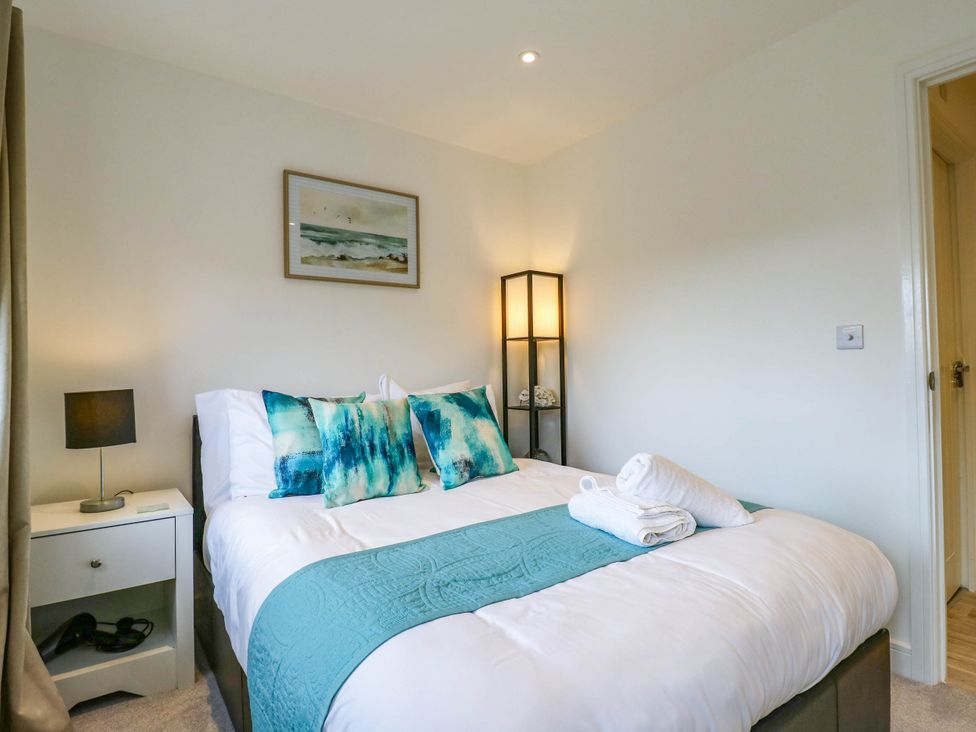 A bedroom with a bed and nightstand at Serenity House