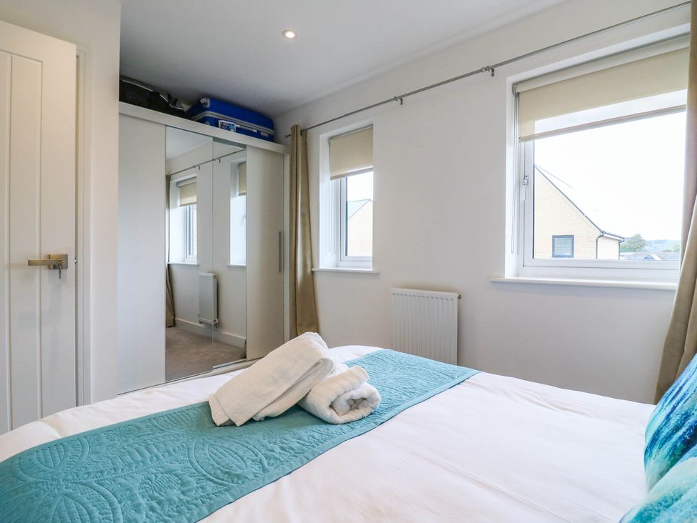 A bedroom with a bed and wardrobe at Serenity House
