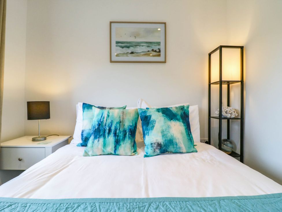 A bedroom with a bed and decorative pillows at Serenity House