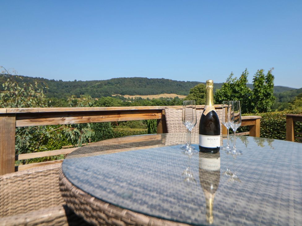 A champagne bottle and glasses on a table in an outdoor seating area at Hillset View Bakewell