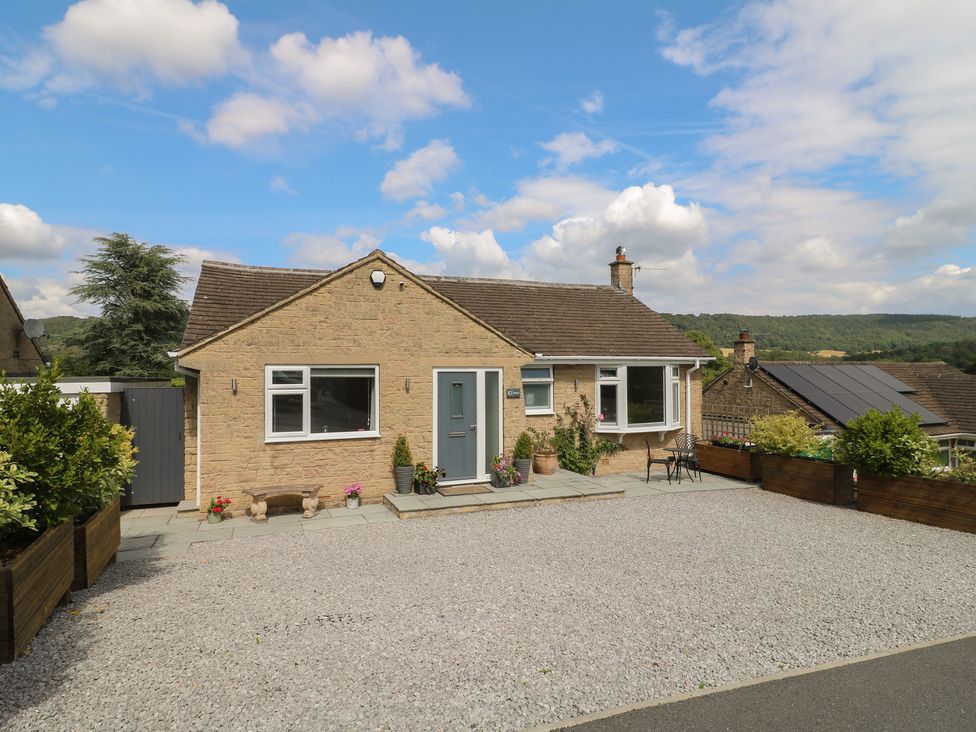 A house with a gravel driveway and plants at Hillset View in Bakewell
