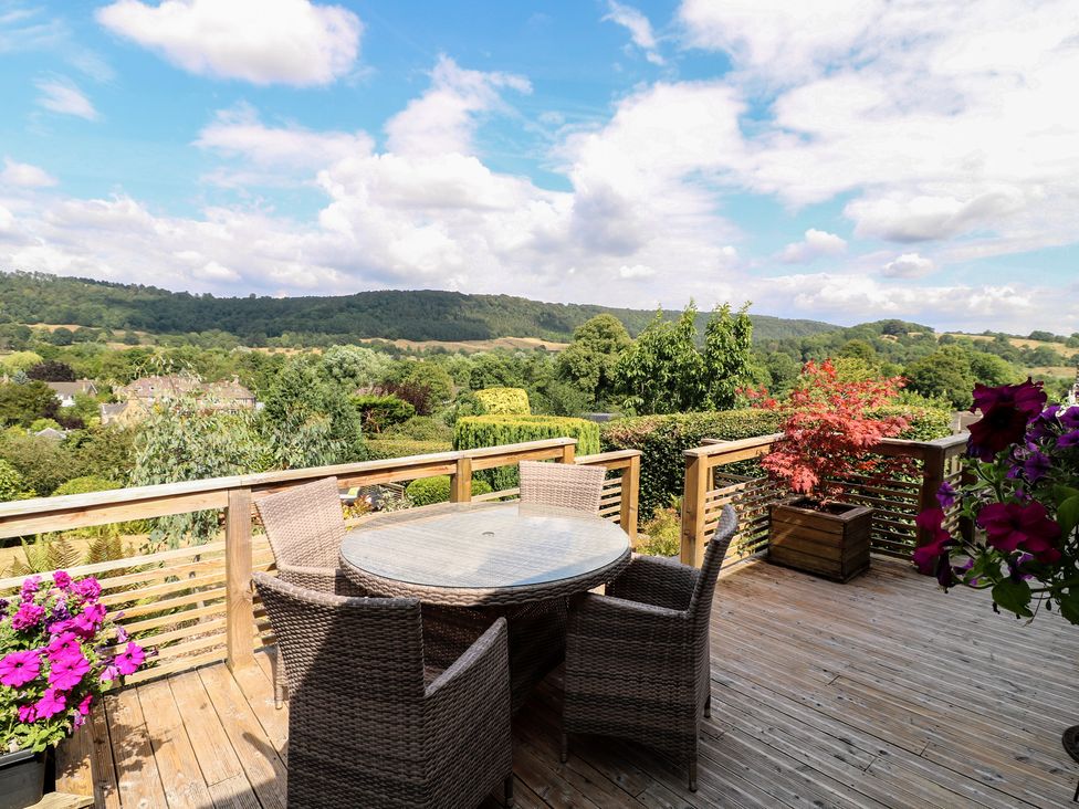 An outdoor space with a table and chairs overlooking a landscape at Hillset View in Bakewell