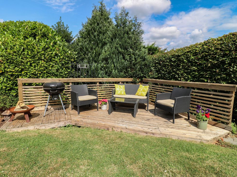 A garden seating area with chairs and barbecue at Hillset View in Bakewell