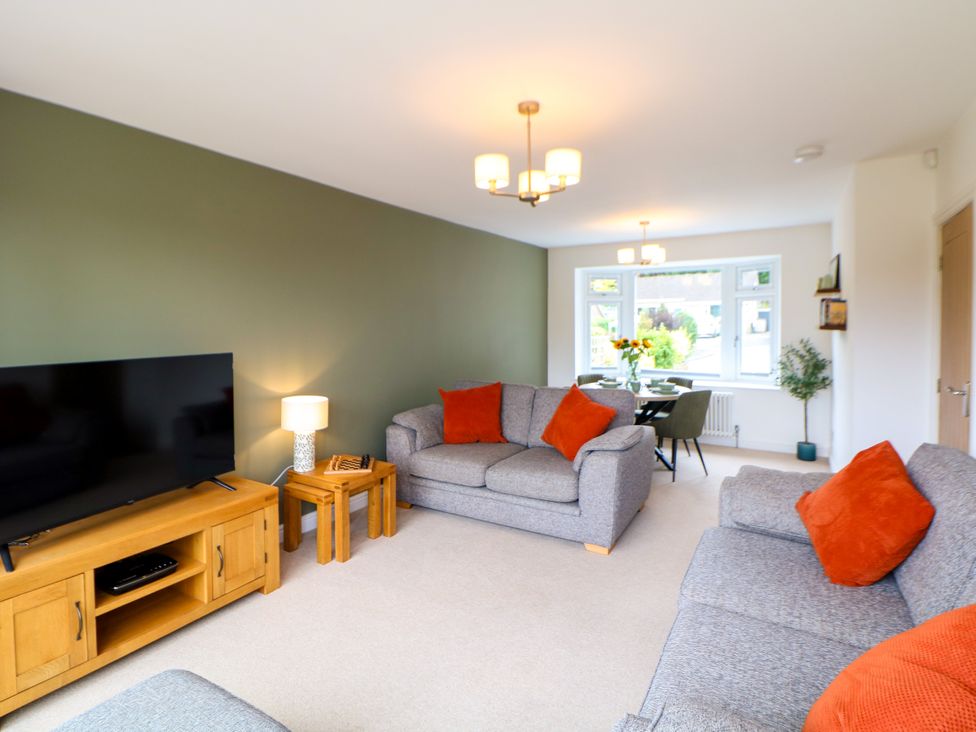 A living room with a sofa and television at Hillset View in Bakewell