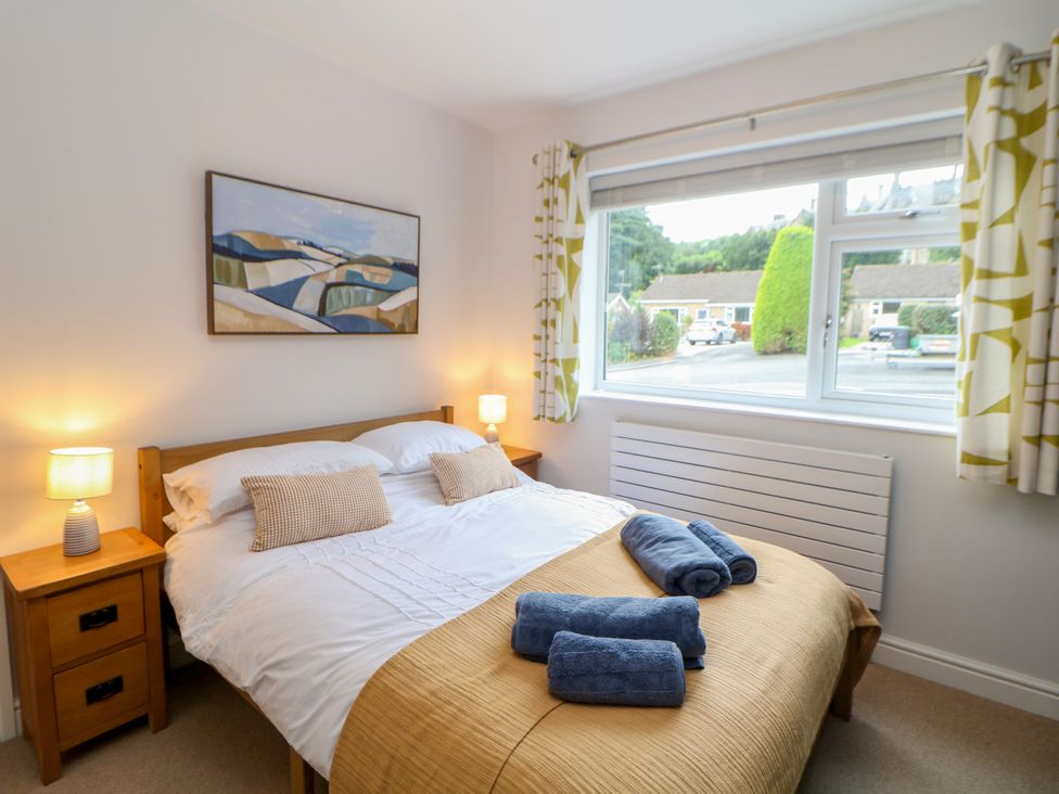 A bedroom with a bed and two nightstands at Hillset View in Bakewell