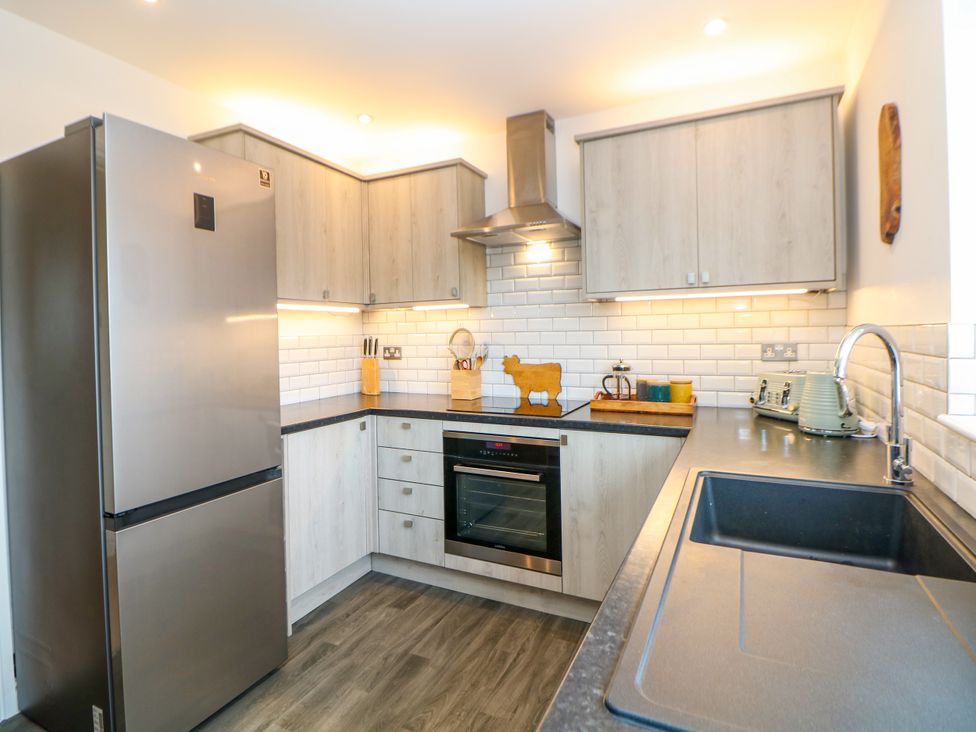 A kitchen with a refrigerator and oven at Hillset View Bakewell