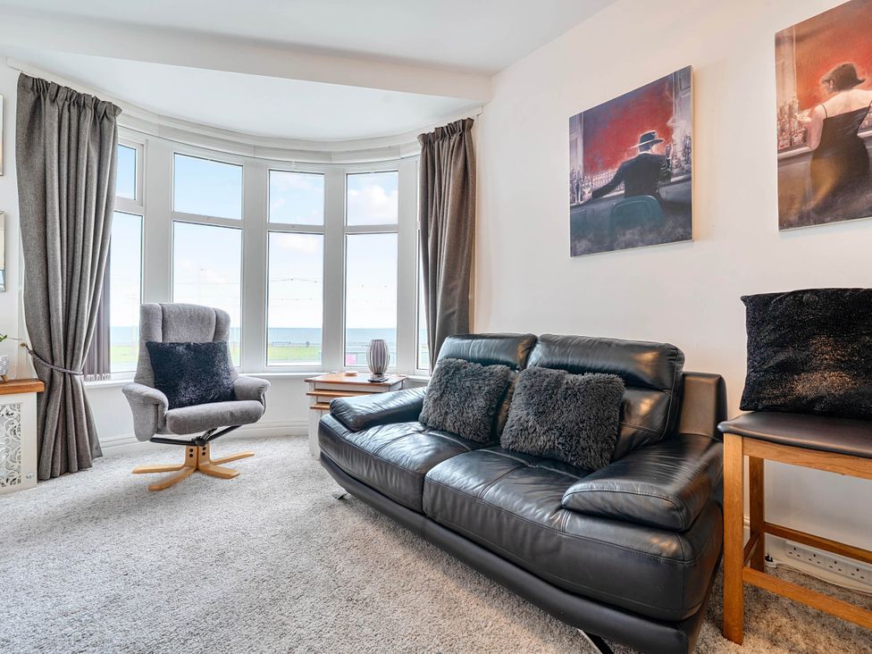A living room with a sofa and armchair at The Old Barn in Bispham