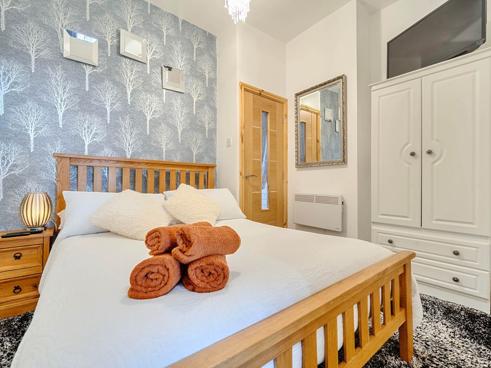A bedroom with a bed and pillows at The Old Barn in Bispham