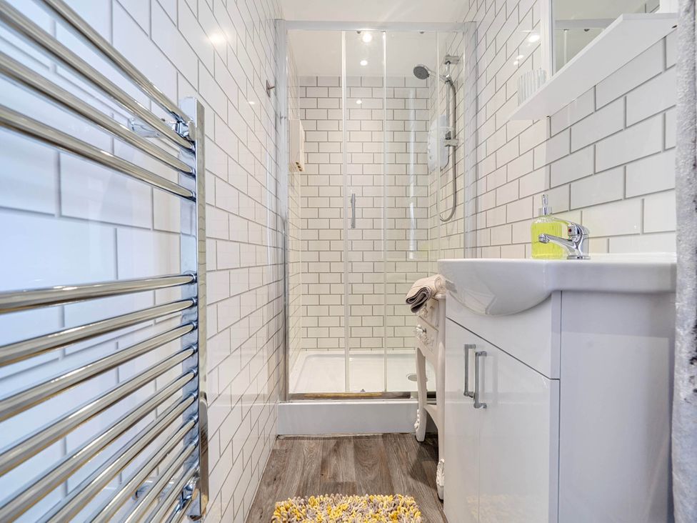 A bathroom with a shower and wash basin at The Old Barn in Bispham