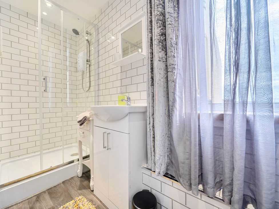 A bathroom with a shower and sink at The Old Barn in Bispham