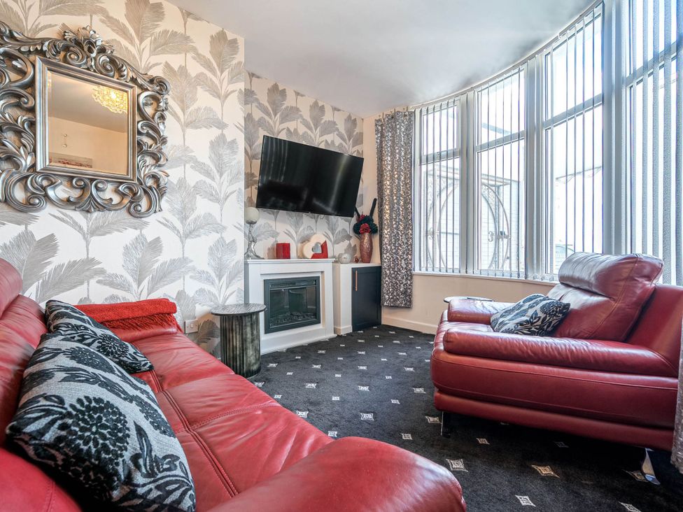 A living room with a television and a fireplace at Ground Floor 1Bed Apartment at SeaCote in Bispham