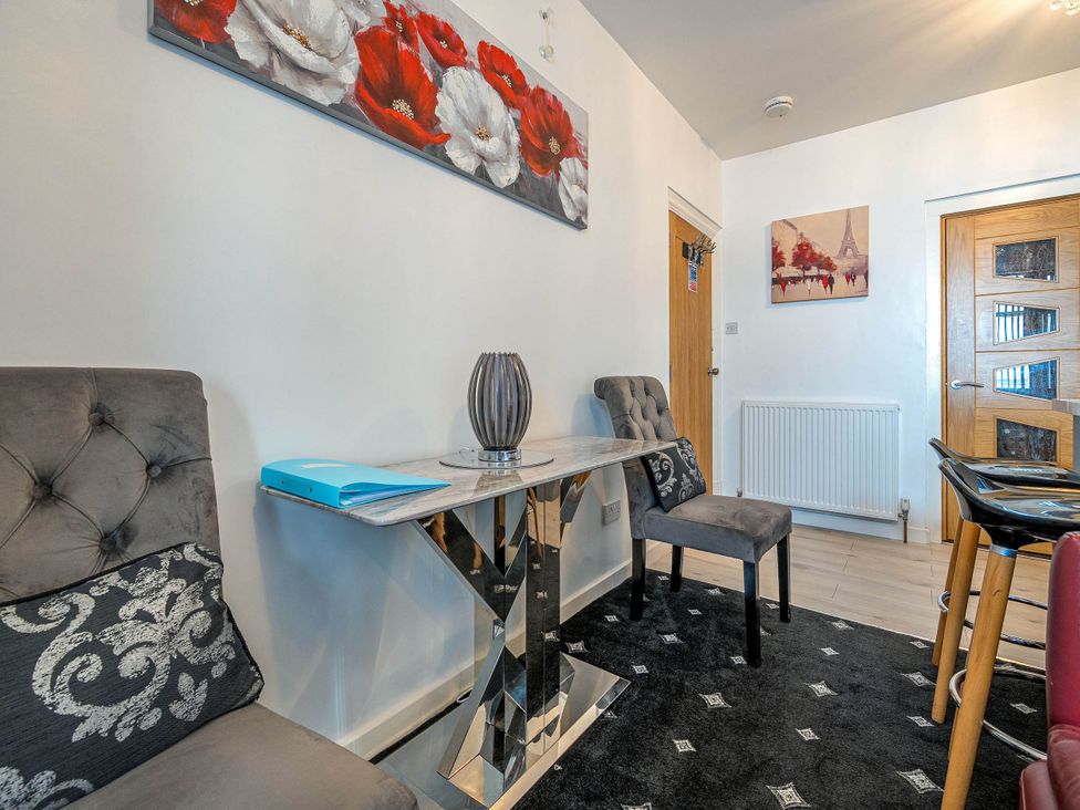 A dining room with a table and chairs at Ground Floor 1Bed Apartment at SeaCote, Bispham