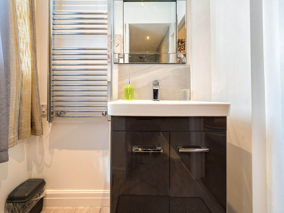 A sink and mirror in a bathroom at Ground Floor 1Bed Apartment at SeaCote Bispham