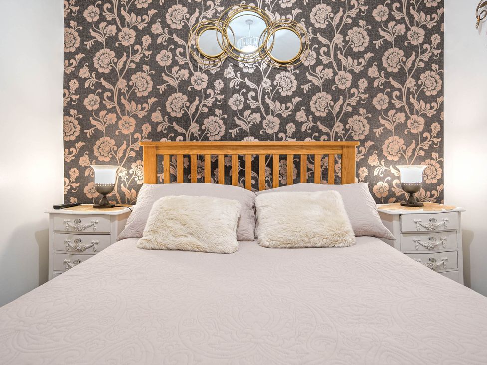 A bedroom with a bed and nightstands at Ground Floor 1Bed Apartment at SeaCote in Bispham
