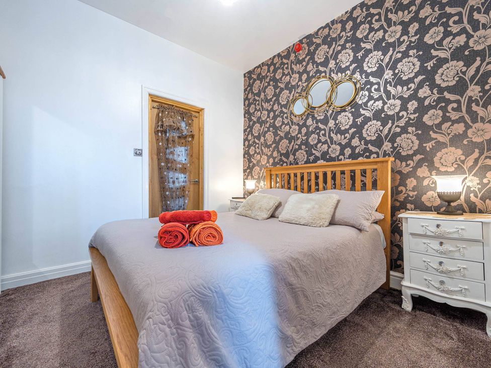 A bedroom with a bed and bedside table at Ground Floor 1Bed Apartment at SeaCote Bispham